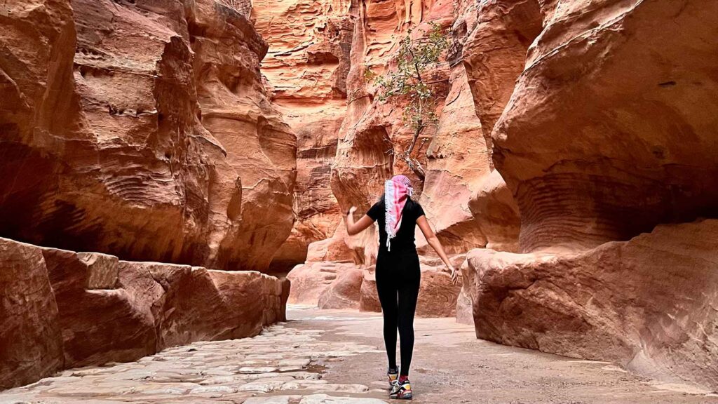 Aurora walking between the canyons in Petra