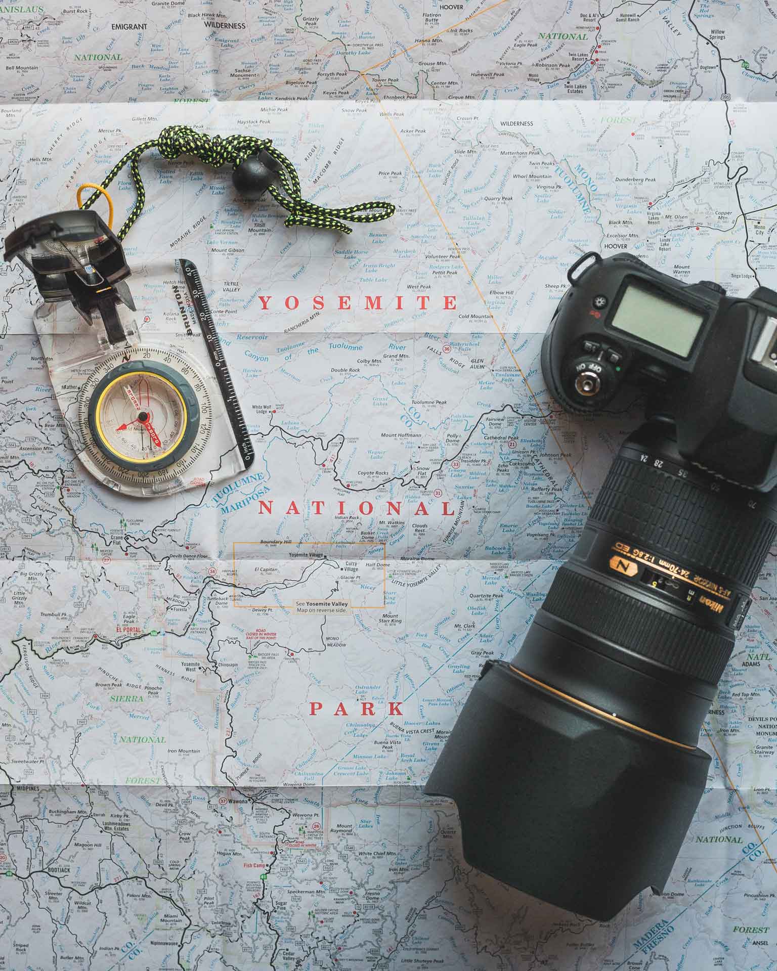 Compass and camera on open Yosemite National Park map